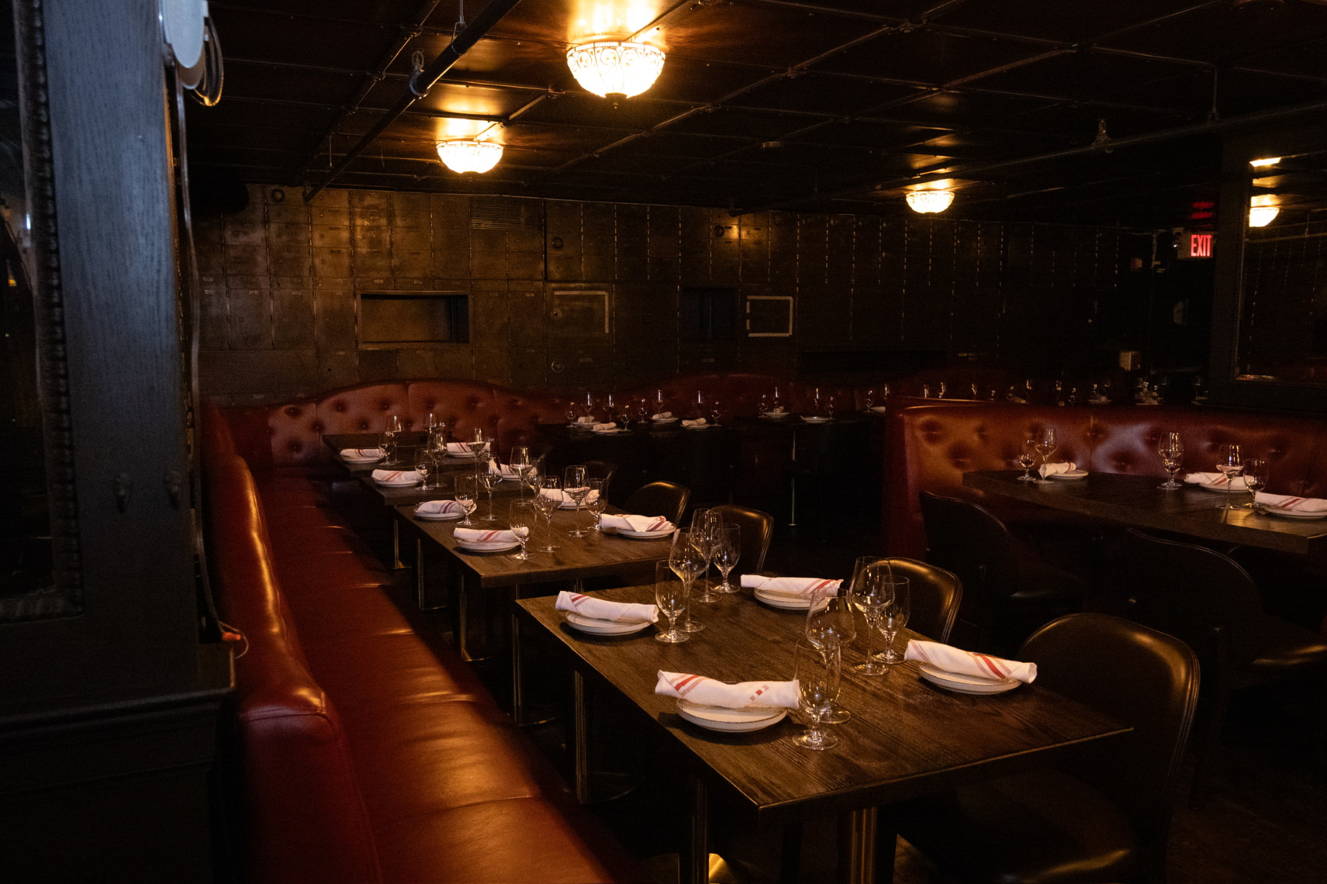Candlelit tables and red leather banquettes in the Bueno dining room
