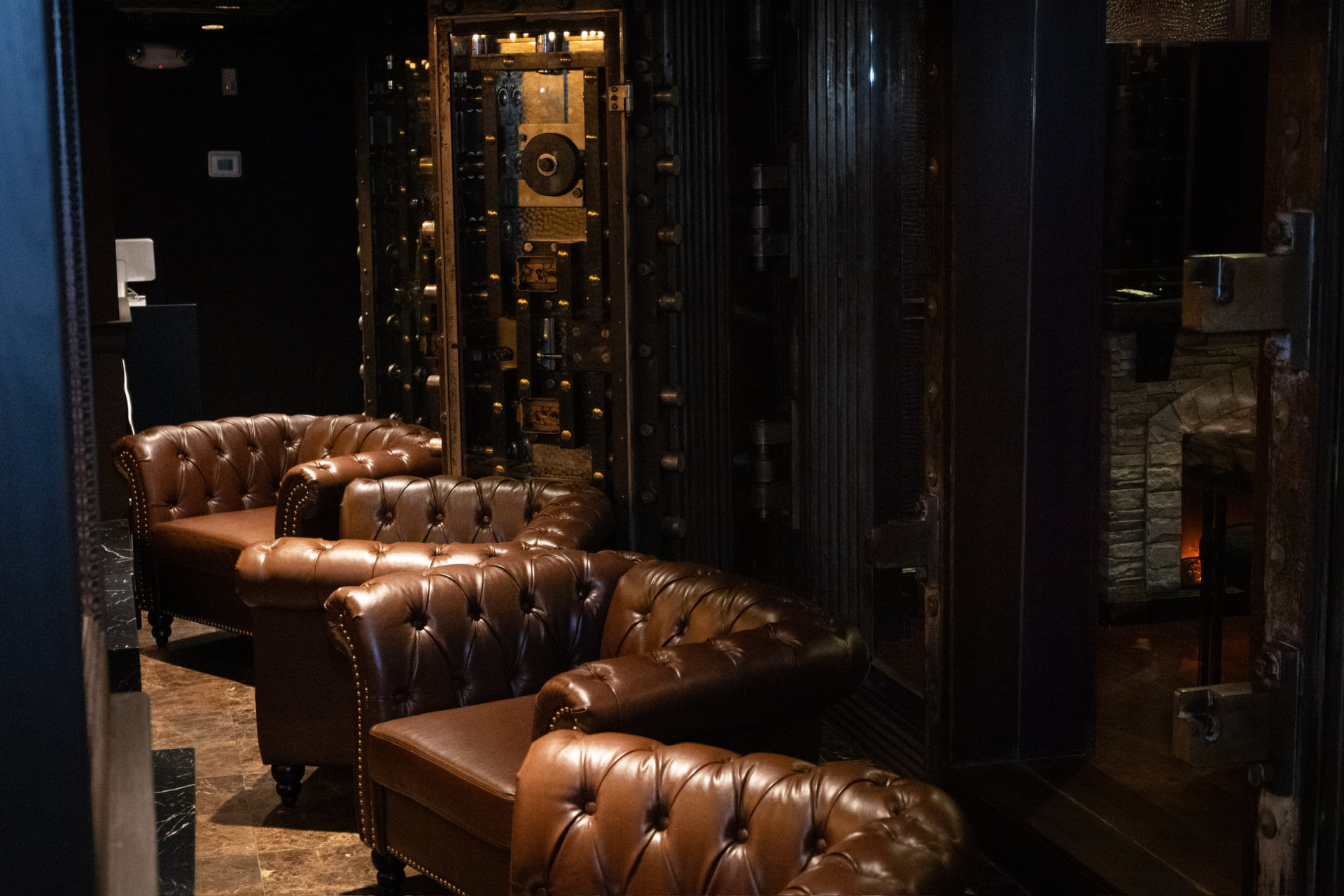 Leather armchairs beside the historic bank vault at Bueno
