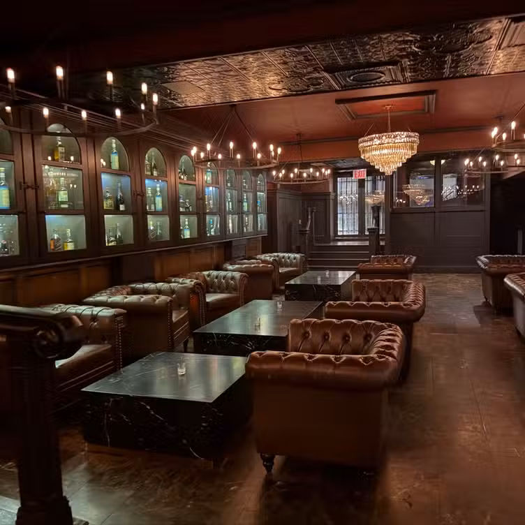 The bar lounge at Bueno, with leather chesterfield sofas and warm low lighting